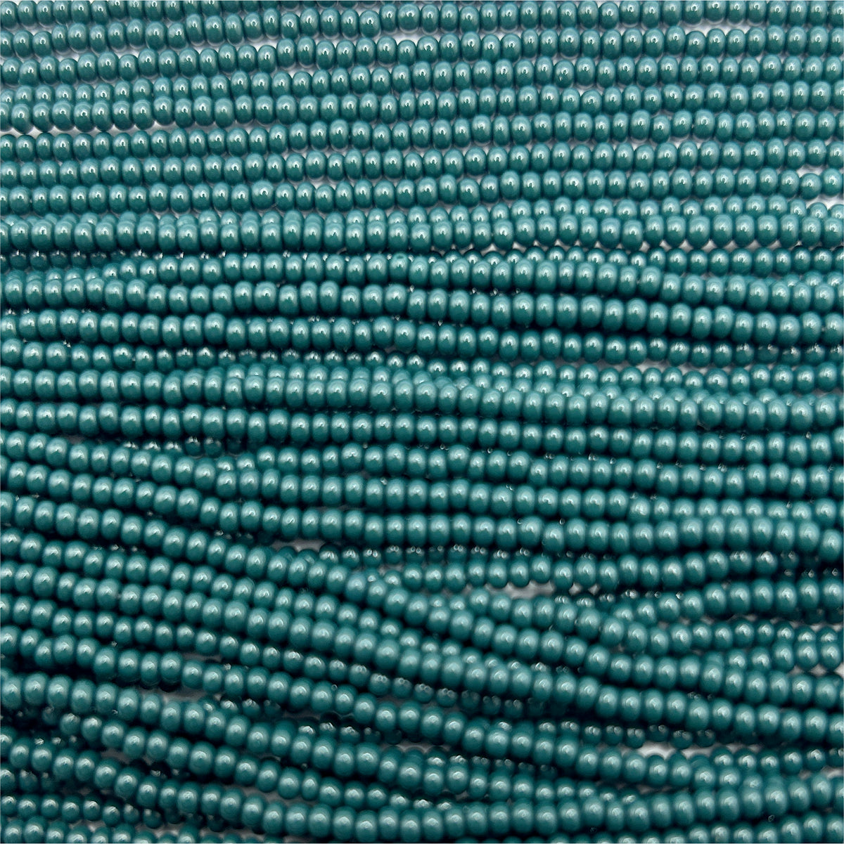 Czech Seed Bead 11/0 Op Dark Green Natural Strung