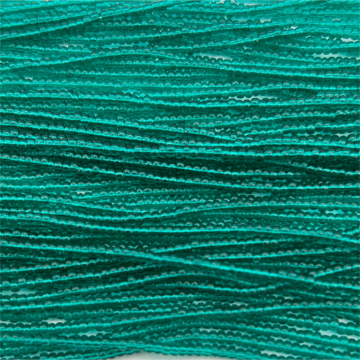Czech Seed Bead 11/0 Transparent Teal Green Strung