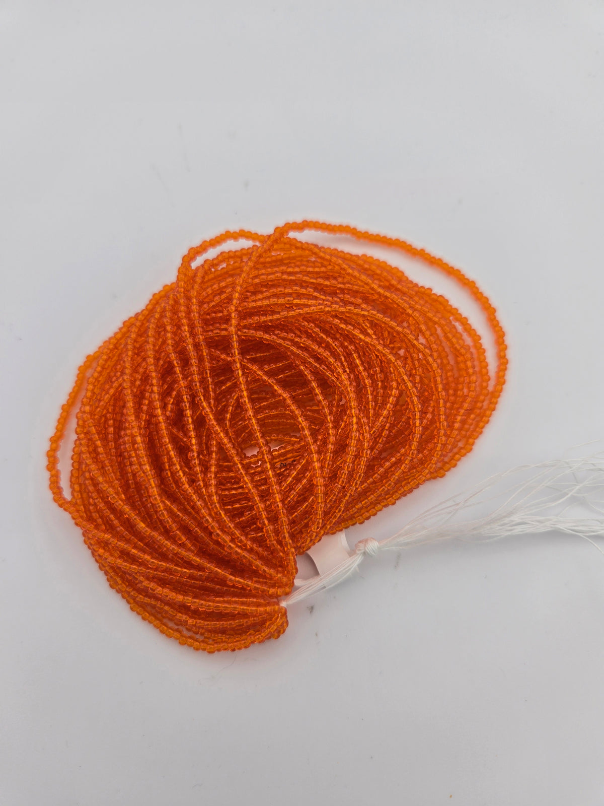 Czech Seed Bead 11/0 Tr Orange Strung
