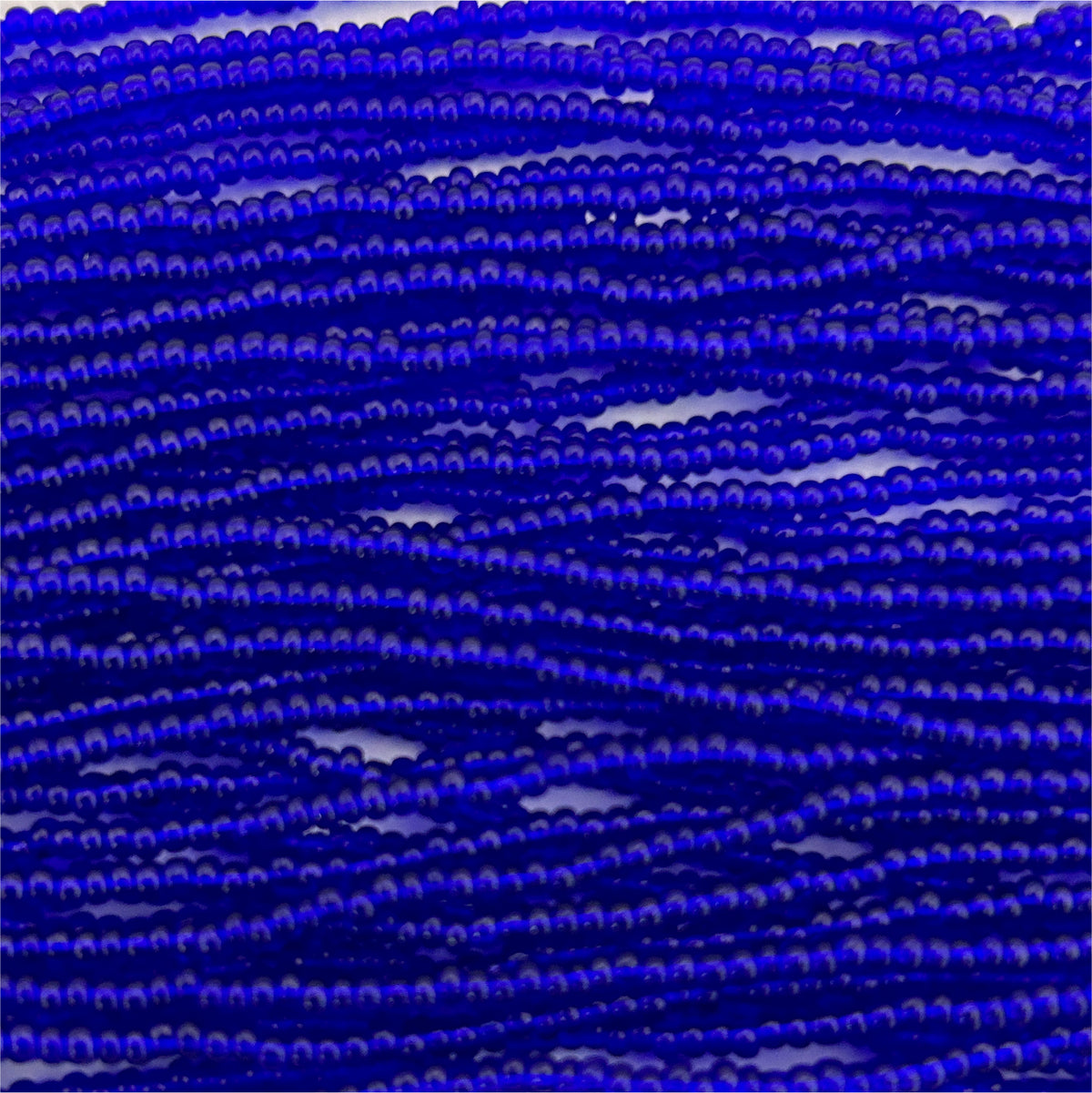 Czech Seed Bead 11/0 Transparent Royal Blue Strung